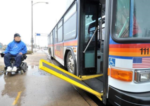 Man in a wheelchair approaching the Metro Bus with a ramp